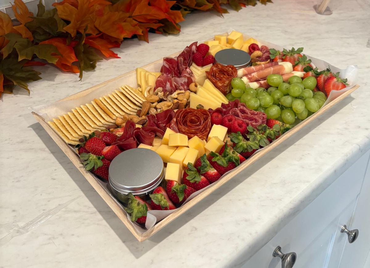 Miora Cheese board boxed with cheeses, grapes, strawberries and crackers, ready for delivery