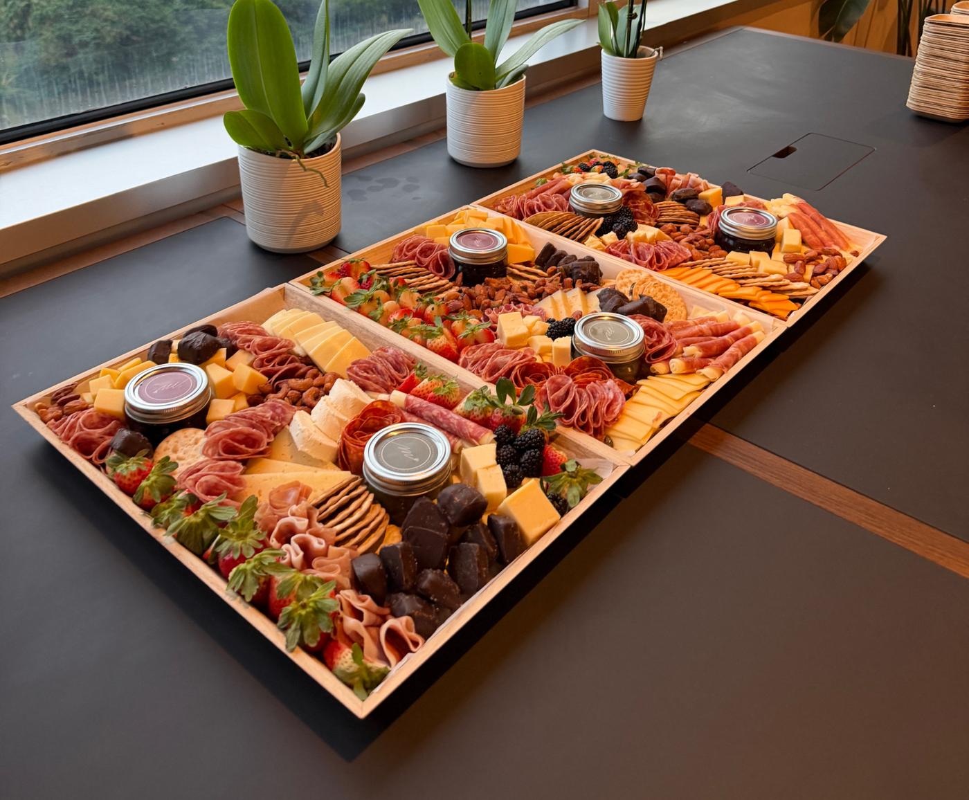 Luxury grazing table with cheeses, charcuterie and fruit laid out for an event